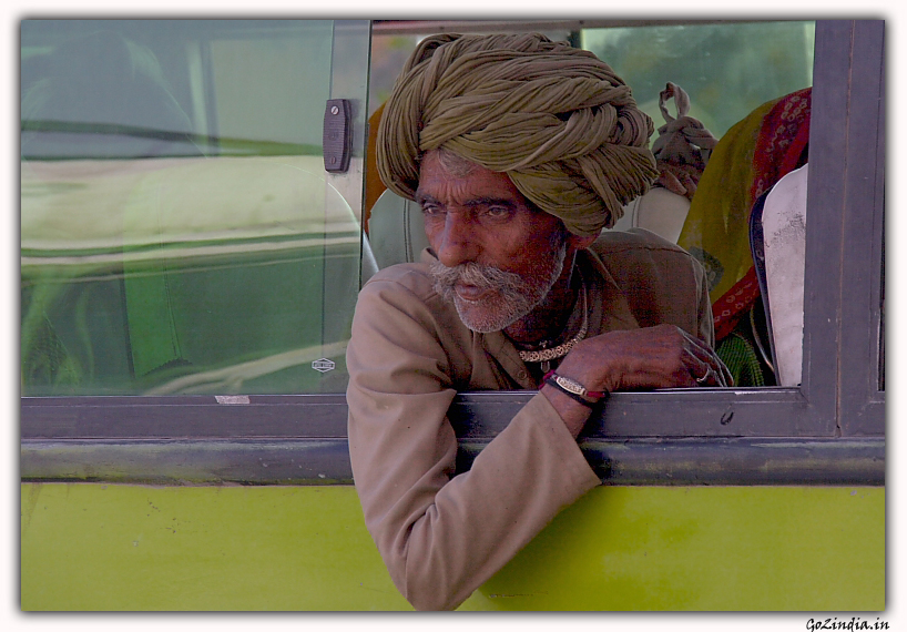 A Man looking from a bus in Rajasthan