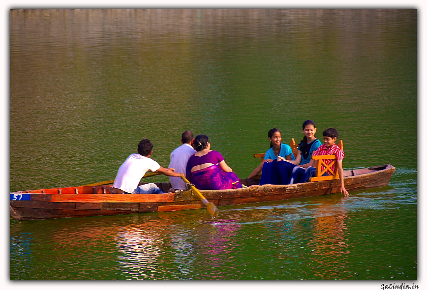 A family enjoying the boat ride in Bhimtal lake.