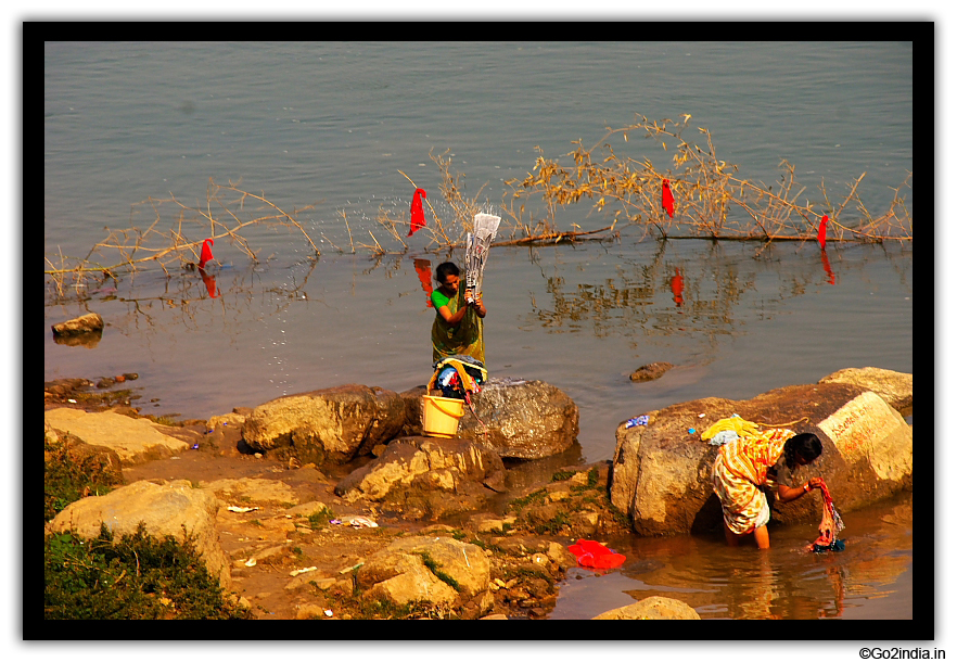 Village washer woman by the side of river bank