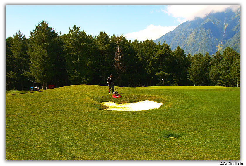 Preparing the grass at Pahalgam golf ground