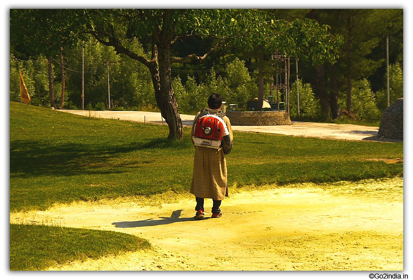 Manusal cutting of grass at Pahalgam
