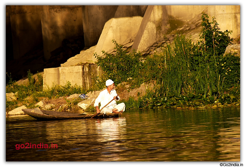 Kashmir man in a boat at Dal Lake