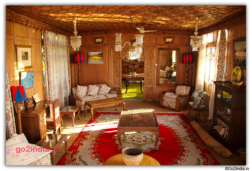 Wooden furnitures and red carpet inside houseboat in Dal Lake Srinagar