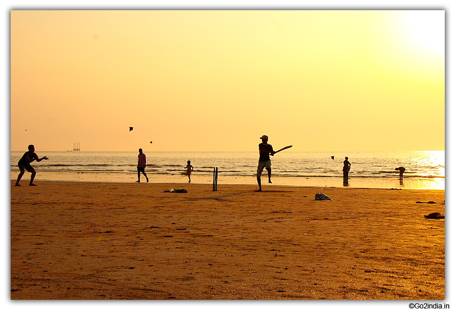 Playing cricket at Juhu beach Mumbai 